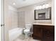 Bathroom featuring shower-tub, light beige walls, vanity with dark wood cabinet, and neutral flooring at 111 Glen Trl, Woodstock, GA 30188