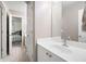 Modern bathroom with large vanity, mirror, and plenty of counter space; bedroom can be seen beyond doorway at 111 Glen Trl, Woodstock, GA 30188