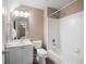 Cozy bathroom features a shower-tub combo, white vanity, and a large, bright mirror at 111 Glen Trl, Woodstock, GA 30188
