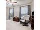 Comfortable bedroom features neutral colors, two bright windows, and a cozy reading chair at 111 Glen Trl, Woodstock, GA 30188