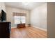 Simple bedroom with hardwood floors, a window with curtains, and space for furniture at 111 Glen Trl, Woodstock, GA 30188
