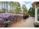 Large wood deck with wisteria, offering outdoor dining and lounging with forest views at 111 Glen Trl, Woodstock, GA 30188