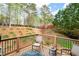 Relaxing backyard deck with seating, overlooking the manicured lawn and mature trees at 111 Glen Trl, Woodstock, GA 30188