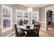 Cozy dining area with a round table, chairs, and large windows providing a view of the deck and backyard at 111 Glen Trl, Woodstock, GA 30188