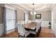 Elegant dining room with tray ceilings, wainscoting, and large windows at 111 Glen Trl, Woodstock, GA 30188