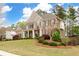 Charming two-story brick home boasts a well-manicured lawn, shutters, and welcoming front porch at 111 Glen Trl, Woodstock, GA 30188