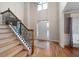 Bright foyer with hardwood floors, staircase with iron spindles, and soaring ceilings at 111 Glen Trl, Woodstock, GA 30188