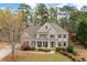 Elegant brick front exterior with a cozy porch, manicured landscaping, and classic architectural details at 111 Glen Trl, Woodstock, GA 30188