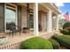 Classic brick front porch with rocking chairs, green shutters, and manicured landscaping at 111 Glen Trl, Woodstock, GA 30188