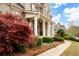 Beautifully landscaped front yard features a winding sidewalk, lush bushes, and mature trees at 111 Glen Trl, Woodstock, GA 30188