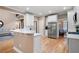 Bright kitchen featuring white cabinets, stainless steel appliances, quartz countertops, and an open layout at 111 Glen Trl, Woodstock, GA 30188