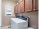 Functional laundry room with storage cabinets and a front-loading washing machine at 111 Glen Trl, Woodstock, GA 30188