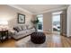 Cozy living room with hardwood floors, neutral paint, and natural light from two windows at 111 Glen Trl, Woodstock, GA 30188