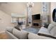 Bright living room with a fireplace, large windows, hardwood floors, and open access to the dining area at 111 Glen Trl, Woodstock, GA 30188
