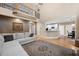 Open living room with high ceilings, hardwood floors, view of the second story, and access to the adjacent kitchen at 111 Glen Trl, Woodstock, GA 30188