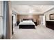 Comfortable main bedroom featuring a tray ceiling and large windows at 111 Glen Trl, Woodstock, GA 30188