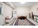 Bright playroom with neutral walls, decorative rug, table with chairs and dollhouse, ready for Gathering fun at 111 Glen Trl, Woodstock, GA 30188