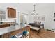 Bright dining area with modern light fixture and access to outdoor patio at 1736 Brookside Lay Cir, Norcross, GA 30093