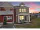 Exterior dusk view of a home with a covered porch, beautiful landscaping and good parking at 1736 Brookside Lay Cir, Norcross, GA 30093