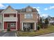 Inviting townhome with a covered front porch seating area and manicured lawn at 1736 Brookside Lay Cir, Norcross, GA 30093