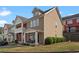 Well-maintained townhome showcases a covered porch with seating and neat greenery at 1736 Brookside Lay Cir, Norcross, GA 30093