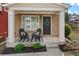 Inviting front porch with chairs and a decorative wreath on the front door at 1736 Brookside Lay Cir, Norcross, GA 30093