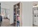 Hallway with glass door cabinet, carpet flooring, and doorways to a bedroom and a bathroom at 1736 Brookside Lay Cir, Norcross, GA 30093
