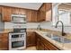 Kitchen features granite countertops, stainless steel appliances, and wood cabinets at 1736 Brookside Lay Cir, Norcross, GA 30093