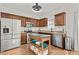 Kitchen with stainless steel appliances, island, and wood cabinets at 1736 Brookside Lay Cir, Norcross, GA 30093