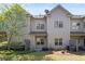 Exterior of townhouse featuring a patio area and back yard with lawn and shrubs at 2251 W Village Se Ln, Smyrna, GA 30080