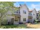 Exterior of townhouse featuring a patio area and back yard with lawn and shrubs at 2251 W Village Se Ln, Smyrna, GA 30080
