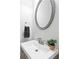 Neat powder room with modern faucet, round mirror and decorative hand towel at 2251 W Village Se Ln, Smyrna, GA 30080