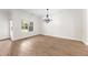 Minimalist dining area with laminate flooring and a modern chandelier at 2251 W Village Se Ln, Smyrna, GA 30080