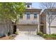 Charming brick townhouse with a two-car garage and well-maintained landscaping at 2251 W Village Se Ln, Smyrna, GA 30080
