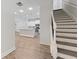 View of white staircase and kitchen, showcasing the seamless flow of the house at 2251 W Village Se Ln, Smyrna, GA 30080