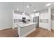 Bright open-concept kitchen with stainless steel appliances, white cabinets, and modern fixtures at 2251 W Village Se Ln, Smyrna, GA 30080