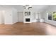 Bright living room with hardwood floors, fireplace, built-in shelving, and natural light at 2251 W Village Se Ln, Smyrna, GA 30080