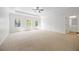 A bright main bedroom with carpet, tray ceilings and plenty of natural light at 2251 W Village Se Ln, Smyrna, GA 30080