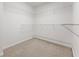Empty walk-in closet with metal shelving and neutral carpet at 2251 W Village Se Ln, Smyrna, GA 30080