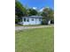 A quaint home displays an enclosed porch, side entry, and a spacious green yard at 3127 Bright Star Rd, Douglasville, GA 30135