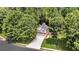 Aerial view of a home with a two car garage, mature landscaping, and mature trees at 3505 Oakshire Se Way, Atlanta, GA 30354
