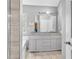 Bright bathroom featuring a double vanity, granite countertops, and updated fixtures at 3505 Oakshire Se Way, Atlanta, GA 30354