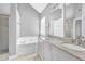 Bright bathroom featuring a double vanity, granite countertops and separate tub and shower at 3505 Oakshire Se Way, Atlanta, GA 30354