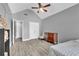 Bright bedroom with a ceiling fan, wooden dresser, grey walls, and updated flooring at 3505 Oakshire Se Way, Atlanta, GA 30354