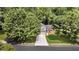 Charming home with lush landscaping, a spacious driveway, and a two-car garage nestled in a tranquil, wooded setting at 3505 Oakshire Se Way, Atlanta, GA 30354