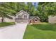 Charming two-story home with a two-car garage, stone accents and a well-manicured lawn at 3505 Oakshire Se Way, Atlanta, GA 30354
