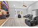 Spacious living room with vaulted ceiling, modern flooring, wood accent wall, and ample natural light at 3505 Oakshire Se Way, Atlanta, GA 30354