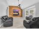 Bright living room with wood accent wall, ceiling fan and natural light from bay windows at 3505 Oakshire Se Way, Atlanta, GA 30354