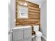 Stylish powder room features wood accent wall and vanity with modern sink at 3505 Oakshire Se Way, Atlanta, GA 30354