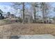 Expansive backyard view featuring trees and a concrete patio, perfect for outdoor relaxation and entertaining at 591 Paper Ridge Ct, Lawrenceville, GA 30046